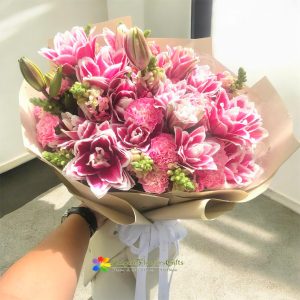 Bouquet of pink lilies mixed with carnations