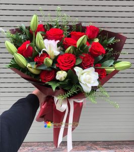 Bouquet of red roses mixed with white lilies